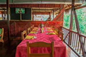 a long dining room with a table and chairs at Caiman Eco Lodge in Aguarico