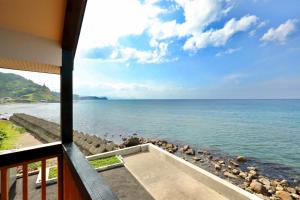 a view of the ocean from the balcony of a house at Otaru Geihinkan in Otaru