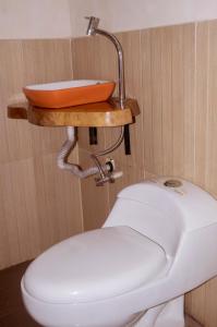 a bathroom with a sink and a toilet at Caiman Eco Lodge in Aguarico