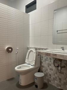 a bathroom with a toilet and a sink at Phu Thai Resort in Sukhothai