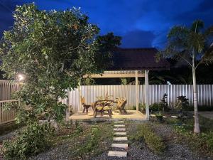 a patio with a table and chairs in a yard at Phu Thai Resort in Sukhothai