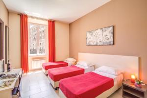 a hotel room with two beds and a window at Hotel Mosaic Central Rome in Rome