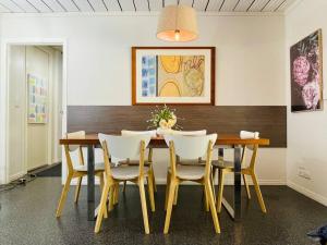 a dining room with a wooden table and chairs at Conifer in Gold Coast