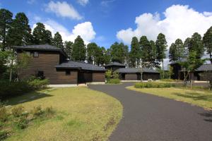 a house with a pathway in front of it at Yamashitako Lodge in Yufuin