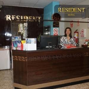 Eine Frau, die an einem Tresen in einem Restaurant sitzt. in der Unterkunft Hotel Resident Piura in Piura
