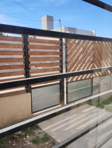 a fence with two windows on the side at Depto Civora 2 in Villa Regina