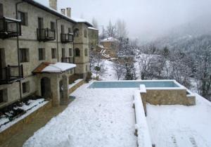 札魯克拉的住宿－斯提加避暑山莊，一座被雪覆盖的游泳池,位于大楼旁边