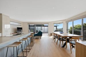 an open kitchen and dining room with tables and chairs at Hazelwood in Cowes