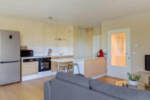 sala de estar con sofá y cocina en Bright one-bedroom in Villeneuve-d'Ascq - Welkeys, en Villeneuve d'Ascq