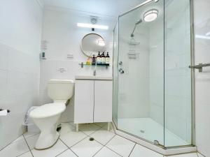 a bathroom with a shower and a toilet at Norman Lindsay Cottage in Faulconbridge