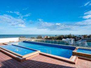 a swimming pool with a view of the ocean at Little Cloud Home Vũng Tàu - CSJ Tower in Vung Tau