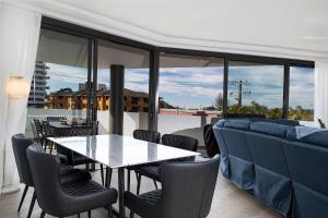 a dining room with a table and chairs at Serenity at Solaris 101 in Forster
