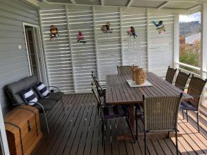 a wooden deck with a table and chairs on it at Rosellas on Corundum Cottage - treat yourself! in Stanthorpe