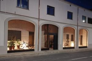 a building with three arches with a bike on it at El paller de L´Armentera 3 in Saldet