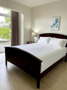 a bedroom with a large bed and a window at Tumon Isa 16 Condo in Tamuning