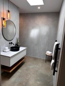 a bathroom with a sink and a mirror at INDICA HEMP HOUSE - Multi Award Winning-Luxury-Eco designed house-lake views-hot tub-Cinema in Wilyabrup +39 photos