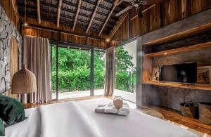 Habitación con bañera grande y ventana grande. en The Ruong Resort, en Vung Tau