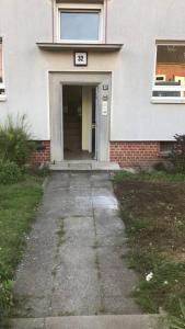 a white house with a door with the number seventysix at 3 Zimmer Ferienwohnung Am Hafen 32/32 in Neustadt in Holstein +18 photos