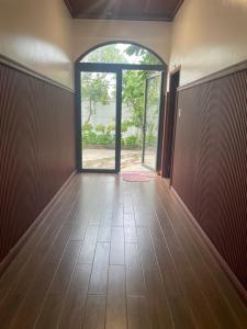 an empty room with an open door and a hallway at Phụng Kim Thảo Hotel Long An in Long An