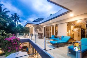 a villa with a swimming pool and a patio at Villa Black Pearl - by Unicorn Villas Bali in Padangbai