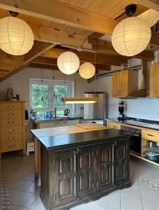 a kitchen with a large wooden island in the middle at Panorama-Suite Birkenbeul in Birkenbeul