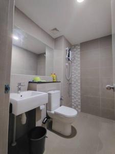 a bathroom with a white toilet and a sink at Summer Mall Summer Suite 2 bedroom unit in Kota Samarahan