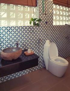 a bathroom with a toilet and a sink at Giang House in Hòa Bình