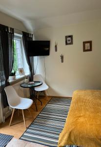 a bedroom with a bed and a table and chairs at Center studio hause in Kaunas