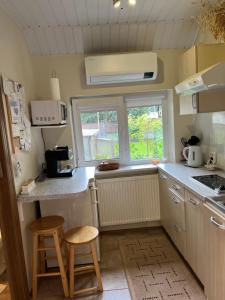 a kitchen with a counter and two stools in it at Center studio hause in Kaunas