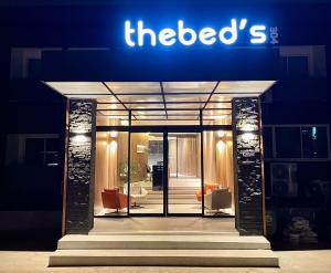 a hotel with a sign on the front of it at The Bed's 304 in Ban Nong Nok