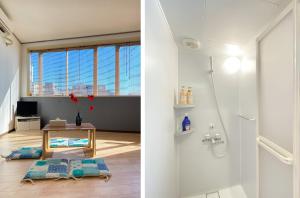 a white bathroom with a shower and a table at Uhome Mitomi Home 3F in Tokyo
