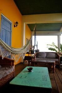 a living room with a hammock and a table at Germaican Hostel in Port Antonio