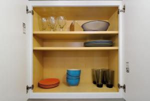 a cupboard filled with plates and bowls and glasses at Studio close to Times Square in New York