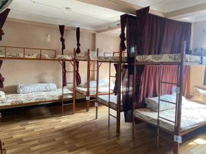 a room with three bunk beds in a room at Planet Nomad Hostel in Kathmandu