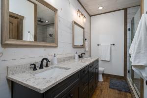 a bathroom with a sink and a mirror at Peaceful Luxury Cabin, hot tub, games, 3 fireplaces in Blue Ridge +40 photos