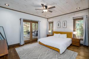 a bedroom with a bed and a ceiling fan at Peaceful Luxury Cabin, hot tub, games, 3 fireplaces in Blue Ridge