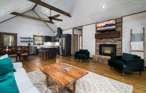 a living room with a table and a fireplace at Peaceful Luxury Cabin, hot tub, games, 3 fireplaces in Blue Ridge