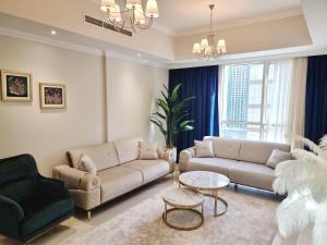 a living room with two couches and a table at Dunya Tower Luxury and 2 min walk to Dubai Mall and Burj Khalifa in Dubai