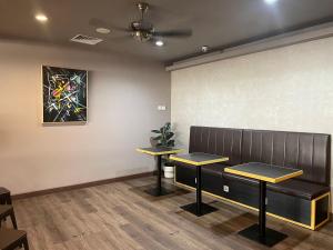a waiting room with two benches and a painting on the wall at PassGo Digital Airport Terminal 2 Soekarno Hatta in Rawabagol