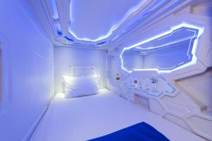 a small room with a bed with a light on it at PassGo Digital Airport Terminal 2 Soekarno Hatta in Rawabagol