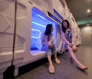 two young women sitting in a train car at PassGo Digital Airport Terminal 2 Soekarno Hatta in Rawabagol