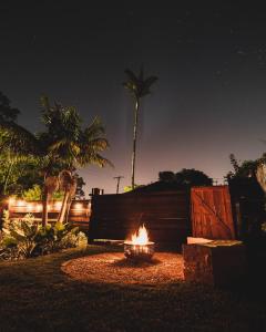 un focolare in un giardino di notte di Tiny home, Outdoor bath, Infrared Sauna, Fire pit a Cardiff