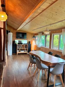 a dining room with a large wooden table and chairs at Chef's Garden 