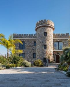 a large brick building with a tower on top at Villa Le Favole in Sant'Egidio del Monte Albino