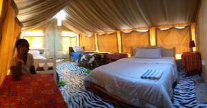 a bedroom with a large bed in a tent at Rhino hillside in Sekenani
