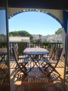Un patio con una mesa y sillas en un balcón. en Apartamento, 3° línea de playa, en Cubelles