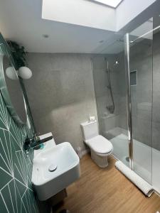 a bathroom with a toilet and a sink and a shower at Central ensuite guest unit with free on-street parking in Brighton & Hove