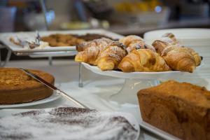 a table with several plates of pastries and bread at Grande Albergo in Sestri Levante