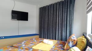 Postel nebo postele na pokoji v ubytování Maria Cristesa Condotel