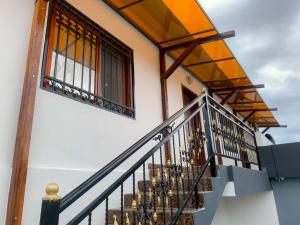 a house with a staircase leading up to a building at Appartement chic in Pointe-Noire